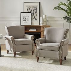 two chairs sitting next to each other on top of a white carpeted room floor