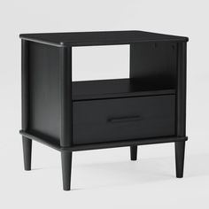 a black night stand with two drawers on one side and an open drawer on the other