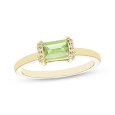 This petite ring is the perfect little pop of color to dress up your finger. Created in 10K yellow gold, the design features a baguette-cut peridot set horizontally and flanked by ribbons of diamond accents atop a slender polished shank. Senior Ring, Senior Rings, August Birthstone Ring, Petite Ring, Gold Book, Peridot Stone, Peridot Ring, August Birth Stone, Baguette Cut