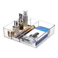 an acrylic container with cosmetics and other items in it