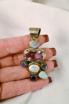 This gorgeous pendant is 925 silver, and set with a variety of semi-precious stones, including amethyst, pearl, opal and labradorite. It would look great on a man or woman, and would be a wonderful gift, even if its for yourself! This wonderful pendant will come to you in a gift box, ready for giving! Total weight on pendant is 24 grams, and it measures 2 1/2 inches by 1 1/4 inches. For more lovely vintage accessories, please visit: www.etsy.com/shop/CloesCloset?section_id=10559789 Unique Sterling Silver Gemstones, Unique Sterling Silver Gemstones With Accents, Silver Gemstone Beads For Jewelry Making, Sterling Silver Fusion Style Natural Gemstones, Silver Pendant Beads With Natural Stones, Artisan Silver Gemstones With Accents, Silver Natural Stones Beads And Cabochons For Gift, Artisan Gemstone Pendant, Unique Natural Stone Pendant Gemstones