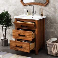 a bathroom vanity with drawers and a mirror on the wall next to a potted plant