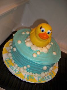 a birthday cake with a rubber ducky on top