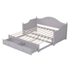 a white bed frame with two drawers on top of it and an open drawer underneath the bed