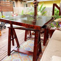 a wooden table sitting on top of a patio