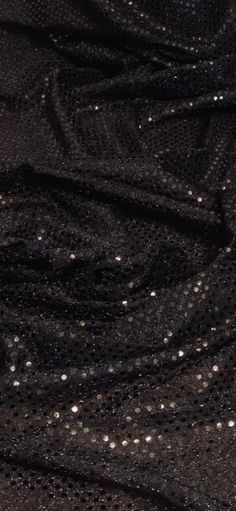 the black fabric has small white dots on it, as well as some other things