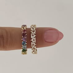 Details: This gorgeous eternity band in 14k gold features rainbow heart-shaped stones all the way around. It is delicate and has the most gorgeous inside detail, alternating up and down hearts as a symbol of eternal love! It’s perfect for stacking with your favorite rings or even as an addition to any wedding ring stack. Size: 3x3mm each (approx) Stones: Amethyst, Garnet, Pink Tourmaline, Lemon Citrine, Citrine, Tsavorite, Swiss Blue Topaz, and London Blue Topaz Available in 14k yellow, white, a Colorful Wedding Ring Stack, Heart Eternity Ring, Wedding Ring Stack, Pink Gold Rings, Rainbow Rings, Rainbow Bracelet, Ring Stack, Matching Bracelet, Swiss Blue Topaz