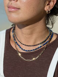 "Inspired by raindrops glistening in the sun, the tiny blue beads strung on this beaded choker necklace have been carved from lapis lazuli stone and faceted to enhance their beauty. ✦ DETAILS ✦ ✧ Name: Kalilinoe (kah lee lee noh eh) - rain. ✧ Adjustable Length from: 14.5\"-17\". ✧ Genuine 2.5mm faceted Lapis Lazuli Beads. ✧ 14kt Gold Filled Components, Extender, and Clasp. ✧ All Ke Aloha Jewelry pieces come packaged thoughtfully, beautifully, and ready for gift giving. ✦ MORE GOLD NECKLACES ➤ ht Everyday Blue Beaded Necklaces, Everyday Blue Beaded Necklace, Blue Beaded Necklace With Colorful Beads For Everyday, Everyday Blue Beaded Necklaces With Colorful Beads, Everyday Blue Beaded Necklace With Colorful Beads, Blue Jewelry With Tiny Beads For Everyday, Blue Beaded Everyday Necklace, Everyday Blue Jewelry With Tiny Beads, Everyday Blue Beaded Necklace With Tiny Beads