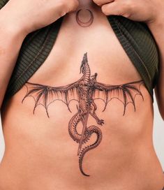 a woman with a dragon tattoo on her stomach