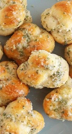 small rolls covered in cheese and herbs on a plate