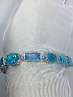 This Blue Topaz and Blue Quartz bracelet is very lively and bright. The stones are deep colors and different tones of blue The sterling silver is plated with rhodium to protect the bracelet from tarnish and give the appearance of white gold. 8 inches All jewelry is shipped in a nice gift box. Check out our over a THOUSAND great reviews Engraving is $4 per letter and is not always perfect depending on the piece. It can take a few days if the jeweler is busy. This is payable to Paypal Judithsltd@g Modern Blue Multi-stone Jewelry, Blue Bracelets With Gemstone Accents As A Gift, Blue Bracelet With Gemstone Accents As Gift, Blue Bracelets With Gemstone Accents For Gift, Elegant Blue Faceted Bracelets, Fine Jewelry Blue Sterling Silver Bracelet As Gift, Modern Blue Jewelry With Accent Stones, Modern Blue Topaz Blue Jewelry, Luxury Blue Bracelets With Gemstone Accents