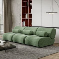 a living room with a large green couch