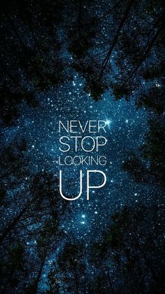 the words never stop looking up are shown in front of trees with stars above them