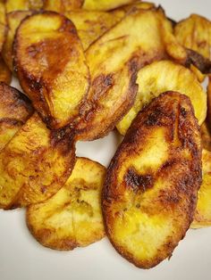 some fried bananas are on a white plate