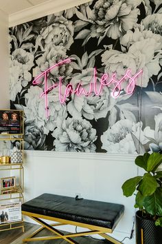 a black and white floral wallpaper with the word fearless written in neon pink on it