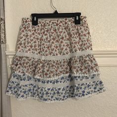 Red And Blue Lace Floral Ruffle Mini Skirt. Never Worn. Super Cute And Comfy. Make Me And Offer/Bundle Casual Red Skirt With Ruffle Hem, Casual White Mini Skirt With Lace Trim, White Lace Trim Mini Skirt, Casual White Skirt With Ruffle Hem, White Ruffle Hem Mini Skirt For Beach, White Mini Skirt With Ruffle Hem For The Beach, White Bohemian Mini Skirt With Floral Print, Bohemian White Mini Skirt With Floral Print, Casual Spring Skirt With Lace Trim