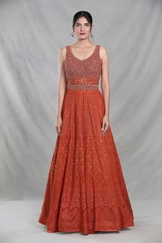 Rust orange sleeveless full length gown with Mughal bloom embroidery using thread, sequin, beads and cutdana highlights. Paired with a ditsy sequin floret work dupatta. - Aza Fashions Anarkali Gown With Resham Embroidery, Sleeveless, Anarkali Gown With Resham Embroidery, Sleeveless Anarkali Gown With Resham Embroidery, Sleeveless Embellished Anarkali Gown, Traditional Sleeveless Hand Embellished Dress, Sleeveless Anarkali Maxi Dress For Reception, Sleeveless Gown With Zari Work For Reception, Reception Dress With Intricate Embroidery, Sleeveless, Sleeveless Reception Dress With Intricate Embroidery