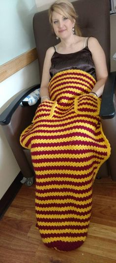 a woman sitting in a chair with a crocheted bag on it's back