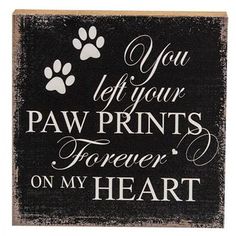 a sign that says, you left your paw prints forever on my heart and an image of