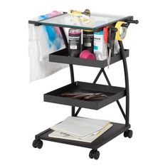 a black cart with two shelves and scissors on it, holding various crafting supplies