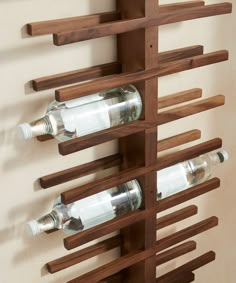 a wooden wine rack with three bottles on it and the words made com above it