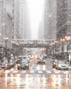 cars are driving down the street on a snowy day in new york city, ny