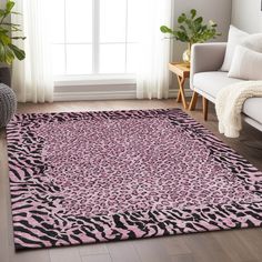 a pink and black rug in a living room