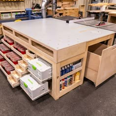 a workbench with lots of drawers and tools in it's center area