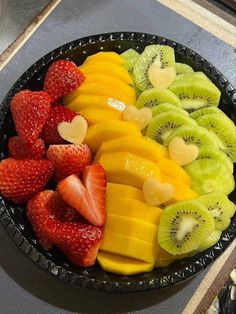 a bowl filled with cut up fruit on top of a counter