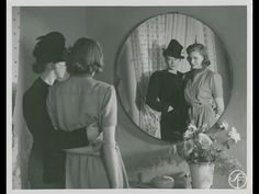 three women are standing in front of a mirror and looking at the same woman's reflection