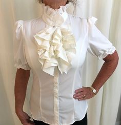 Vintage short sleeved high neck white ruffle blouse.  Sz:  XS 31" Bust 13.5" Shoulder 24". Length Excellent Condition White Ruffled Blouse For Office, Formal White Ruffled Shirt, White Ruffled Shirt For Formal Occasions, White Ruffled Tops For Office, Formal White Short Sleeve Blouse, White Short Sleeve Formal Blouse, White Ruffled Collar Blouse With Ruffles, White Ruffle Sleeve Office Blouse, White Puff Sleeve Blouse With Ruffles