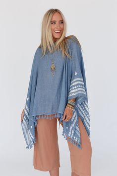 The Fallon Embroidered Sleeve Poncho you know and love, but NOW offered as the Fallon Embroidered Sleeve Tassel Poncho! We know you'll love wearing this poncho because it features: Lightweight flowy woven fabric Flowy poncho silhouette (no sleeves, edges tacked with a small seam) So cute embroidered geometric shapes along bottom edge Finished with a cute tassel bottom edge Comfortable boho outfit you'll love pair with: Floral Cut Out High Neck Bralette, Delaney Distressed Wide Leg Pants, Sunburs Blue Long Sleeve Poncho For Festivals, One Size Blue Poncho With Fringe, Blue Bohemian Poncho, Blue One-size Poncho With Fringe, Cozy One-size Poncho With Batwing Sleeves, Boho Essentials, Bralette Outfit, Boho Outfit, Denim Day