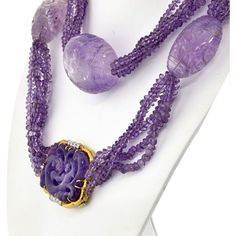 Indulge in the captivating allure of this exquisite David Webb Lavender Bead Necklace. Handcrafted with meticulous attention to detail, this necklace is a testament to the brand's impeccable craftsmanship. Each of the five strands features lustrous amethyst beads, showcasing their enchanting lavender hue.Adding to its allure are the large egg-shaped amethyst stations, creating a striking focal point. These impressive amethysts, measuring about 4.5cm in length and 10cm in diameter, exude a sense Exquisite Formal Amethyst Necklace, Exquisite Amethyst Necklace For Formal Occasions, Luxury Amethyst Necklace For Formal Occasions, Luxury Amethyst Briolette Jewelry, Luxury Briolette Amethyst Jewelry, Elegant Lavender Necklaces With Natural Stones, Lavender Gemstone Necklace For Formal Occasions, Exquisite Purple Necklace, Elegant Amethyst Round Bead Necklaces