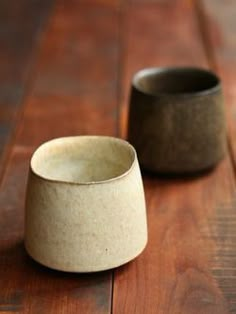 two bowls sitting on top of a wooden floor