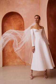 a woman in a white wedding dress and veil