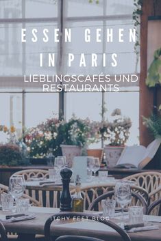 an outdoor restaurant with tables and chairs in front of large windows that have plants growing on them