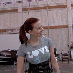 a woman standing in front of a basketball hoop