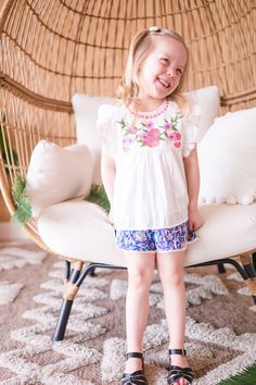 Introducing our newest blouse and short set! This adorable two-piece features a beautiful floral embroidered cotton blouse, paired with colorful block print shorts with little lace trim. She'll look absolutely precious in this ensemble - perfect for a day of play! Short Cotton Tops With Floral Print, Cotton Floral Print Short Tops, White Floral Embroidery Sets For Vacation, Embroidered Short Sleeve Summer Sets, Summer Embroidered Short Sleeve Sets, White Embroidered Vacation Sets, Cotton Beach Sets With Floral Embroidery, Beach Sets With Floral Embroidery In Cotton, Cute Matching Set Tops For Vacation