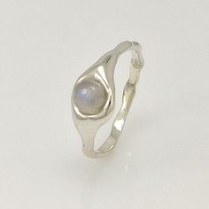 ✔️About the ring Dainty sterling silver ring with moonstone. Geometrical balance of the ring brings a simple chic and elegance. Will be a beautiful accessory for everyday outfits and special occasions. A perfect gift for someone you love or for yourself! ✔️Dimensions of the stone  5 mm round. ✔️Material 100% sterling silver. Without any coating. ✔️Size All sizes are available. If you don't know your finger size, here is a simple way to measure it: 1. Wrap string or paper around your finger. Make sure not to make it too tight. 2. Mark the point where the ends meet. 3. Measure the string or paper with a ruler (mm). 4. Pick the closest measurement on the ring size chart (can be found on the last photo). ✔️Shipping Free shipping worldwide.  ✔️Packing All my jewellery will come to you packed se Wavy Ring, Freeform Ring, Ring Moon, Ring Size Chart, Ring Moonstone, Liquid Metal, Simple Chic, Ring Boho, Boho Ring