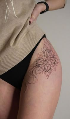 a woman with a tattoo on her thigh