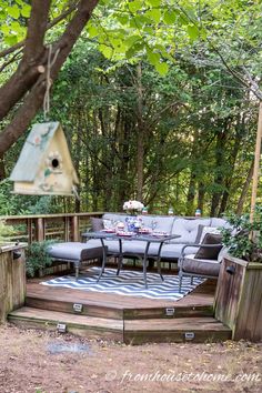 an outdoor seating area in the woods