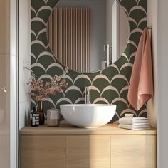 a bathroom with a sink, mirror and towel hanging on the wall next to it