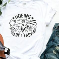 Gardener ,Farmer Or Plant Lover “ Hoeing Ain’t Easy” Gildan Cotton T-Shirt Nwt ($16 For Small,Medium And Large) Homestead Shirt, Funny Plant Sayings, Plant Sayings, Plant Store, Gardening Shirts, Merch Ideas, Book Writing Tips, Simple Shirts, Book Writing