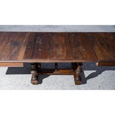 a wooden table sitting on top of a cement floor