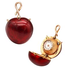 Enameled pendant bezel wind watch in the shape of a cherry. Fantastic miniature cherry shaped pendant watch, created in Switzerland, back in the 1910-1920. The movement is mechanical, bezel wind and the case was crafted in solid yellow gold of 18 karats with applications of foiled vivid red enamel. Fitted on top with a twisted steam simulating the cherry branch. It was made in two parts with an invisible tension hinge and a push lock to be open and discover as a surprise, the miniature watch in Miniature Watch, Cherry Branch, Pendant Watch, Pendant Watches, Gold Dots, Gold Hands, The Movement, Solid Yellow, White Porcelain