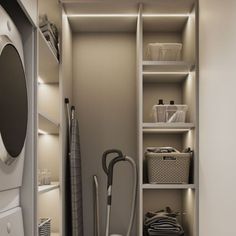 a washer and dryer in a small room with shelves on the wall,