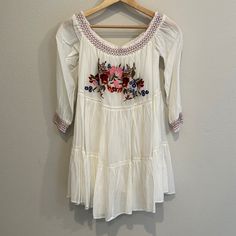 Nwt Xs Free People Ivory Sun Beams Embroidered Mini Dress! Second Owners. Purchased From Posh. Perfect Condition With Tags Still Attached. Smocked Of The Shoulder Neckline And Sleeve Cuffs. Floral Embroidery On The Front. Fully Lined. White Embroidered Mini Dress For Spring, Embroidered White Long Sleeve Mini Dress, White Embroidered Long Sleeve Mini Dress, White Long Sleeve Embroidered Mini Dress, White Dress With Embroidered Hem, Cream Cotton Dress With Floral Embroidery, White Embroidered Mini Dress For Vacation, White Embroidered Mini Dress For Brunch, Fitted Embroidered Off White Dress