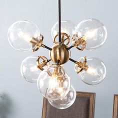 a chandelier with five clear globes hanging from it's center point