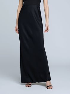 A stunning, understated maxi skirt in pure black. Bias-cut, silk-like fabric falls in a subtle, lustrous cling over the figure, enhancing and elongating the silhouette. Smooth elastic waist with no closures. Full Length Satin Finish Maxi Dress, Elegant Floor-length Satin Skirt, Sleek Full-length Bias-cut Maxi Dress, Elegant Full Length Evening Skirt, Satin Floor-length Evening Skirt, Formal Silk Bias Cut Skirt, Elegant Full-length Lined Maxi Skirt, Elegant Formal Full-length Maxi Skirt, Chic Full Length Silk Maxi Skirt