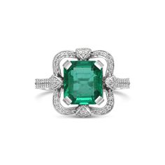 Metal: 14K White Gold Gemstones: 3.10 Cts. Emerald 0.35 Cts. Diamond Luxury Emerald Ring With Halo Diamond Design, Luxury Heart Cut Emerald Ring For Formal Occasions, Gia Certified Elegant Emerald Gemstones, Elegant Gia Certified Emerald Gemstones, Elegant Cushion Cut Gemstone With Center Stone, Elegant Cushion Cut Gemstones, Luxury Emerald Cut Gemstone Halo Ring, Classic Platinum Gemstones With Halo Setting, Luxury Diamond Ring With Emerald Accent Stones